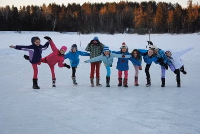 Students balancing on one leg on a frozen lake
