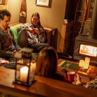 Group sitting around the fireplace in Magnetawan Chalet Suite