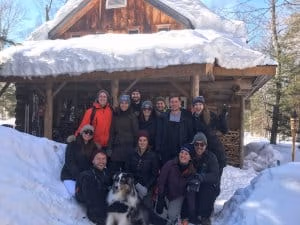 Algonquin Private Log Cabin group in the snow in front of the Algonquin Log Cabin