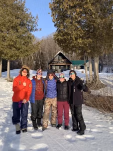 Winter group picture in front of the Duke of Edinburgh homebase at Algonquin
