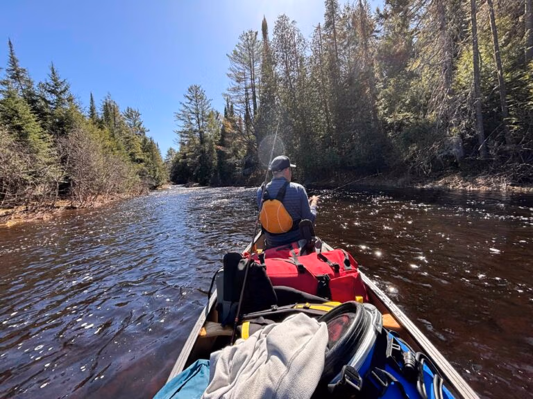 canoe trip with loaded canoe at rapids
