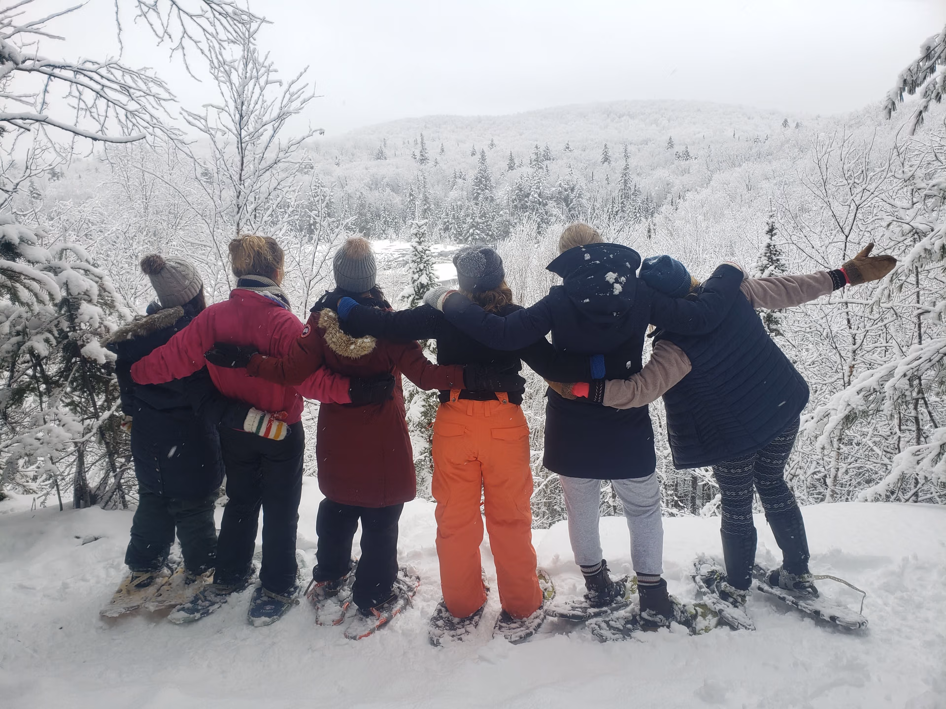 Snowshoe group at a lookout on the trails from the Log Cabin door