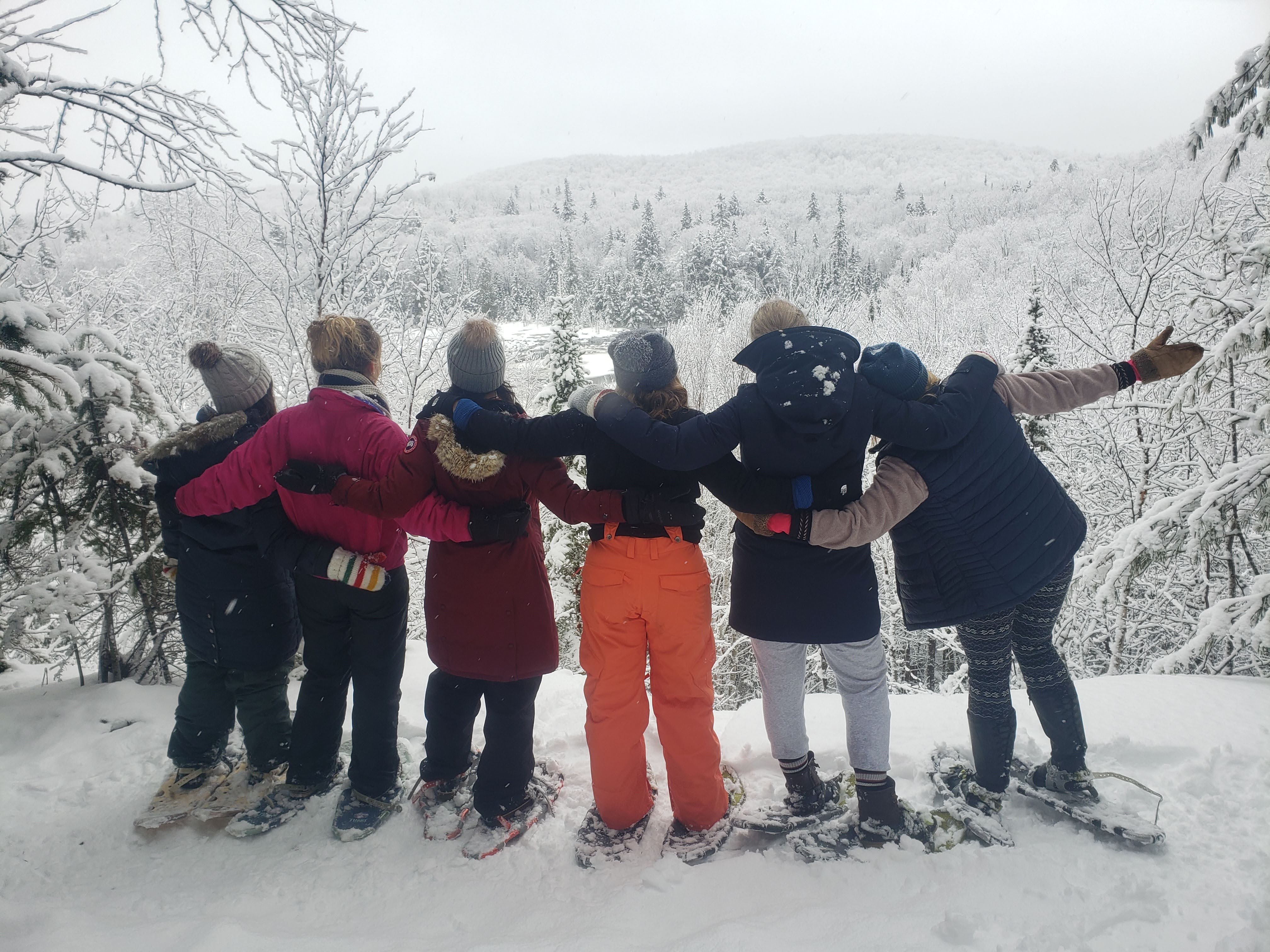 Snowshoe group at a lookout on the trails from the Log Cabin door