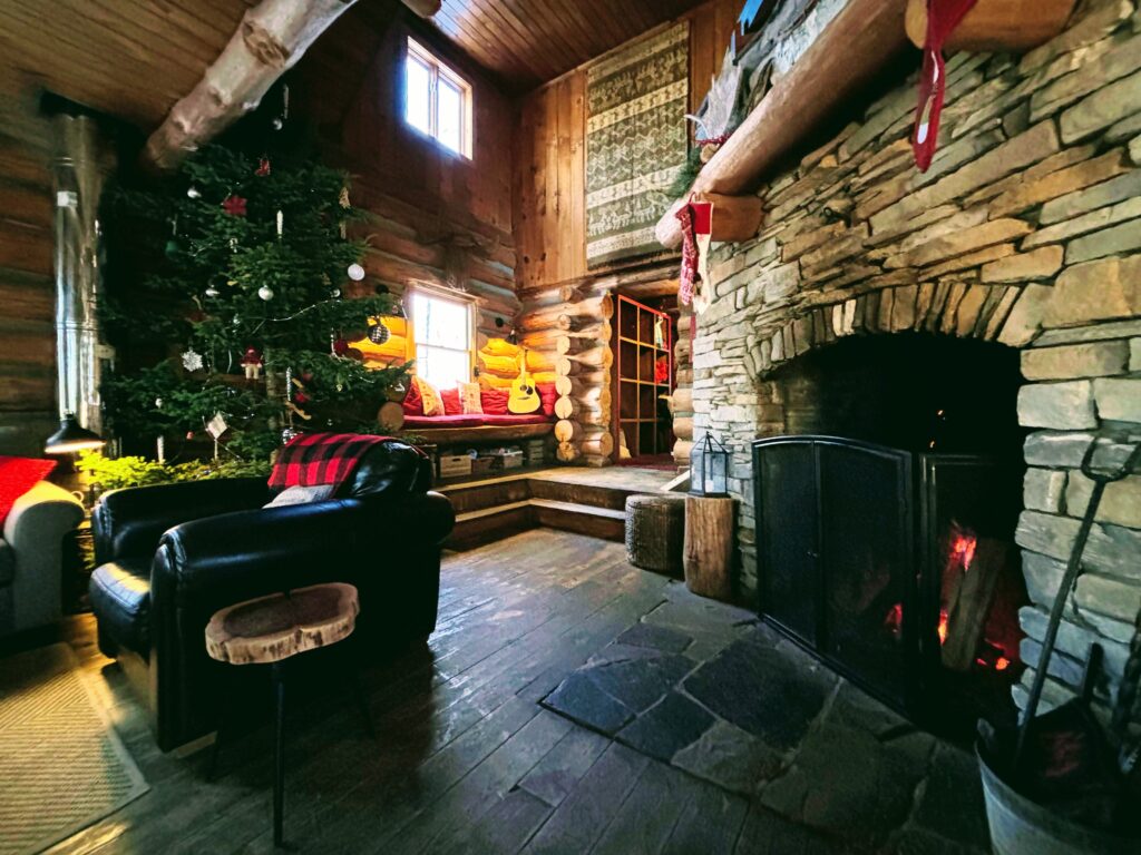 Log Cabin Christmas with tree and fireplace